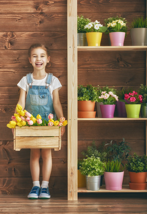 girl holding tulip planter